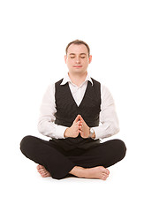 Image showing businessman sitting in lotus pose