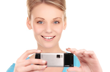 Image showing happy woman using phone camera