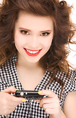 Image showing happy teenage girl with digital camera