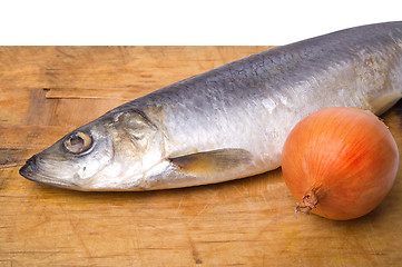 Image showing Herring with onion on old wooden cutting board