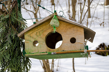 Image showing wooden bird feeder with three holes 