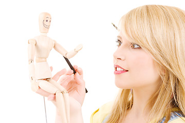 Image showing happy teenage girl with wooden model dummy