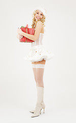 Image showing cheerful santa helper girl with gift box