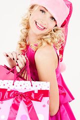 Image showing cheerful santa helper girl with shopping bags