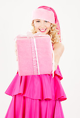 Image showing cheerful santa helper girl with gift box