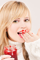 Image showing happy teenage girl with raspberry jam