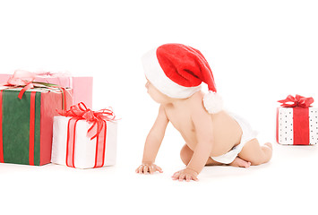 Image showing santa helper baby with christmas gifts