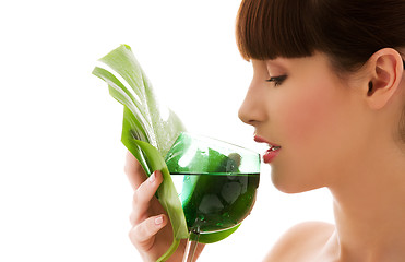 Image showing woman with green leaf and glass of water