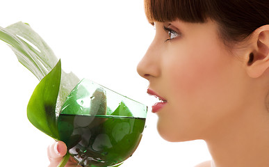 Image showing woman with green leaf and glass of water