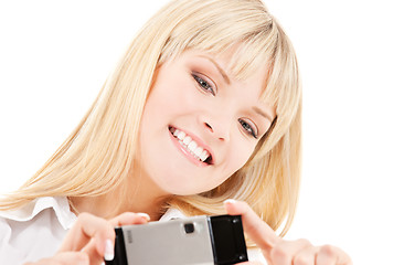 Image showing happy woman using phone camera