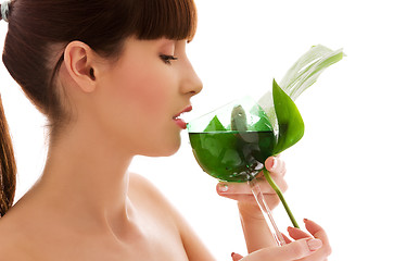 Image showing woman with green leaf and glass of water