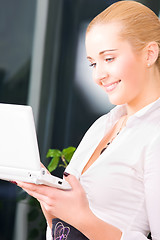 Image showing happy businesswoman with laptop computer