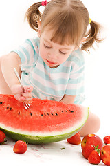 Image showing little girl with strawberry and watermelon