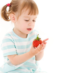 Image showing little girl with strawberry