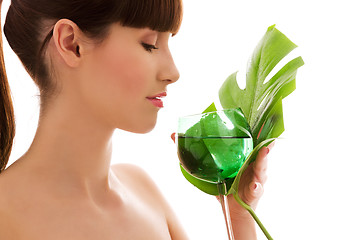 Image showing woman with green leaf and glass of water