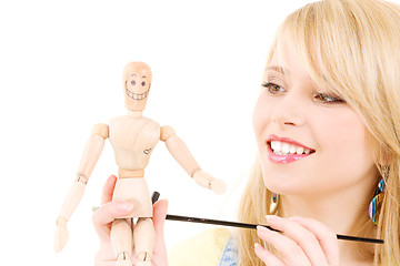 Image showing happy teenage girl with wooden model dummy