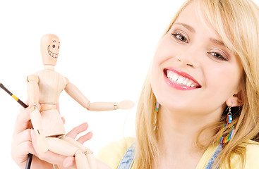 Image showing happy teenage girl with wooden model dummy