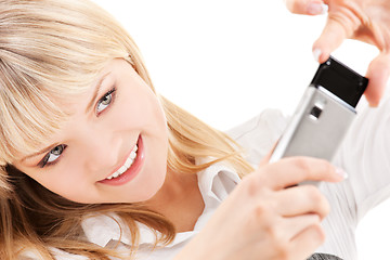 Image showing happy woman using phone camera