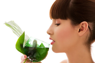 Image showing woman with green leaf and glass of water