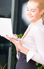 Image showing happy businesswoman with laptop computer