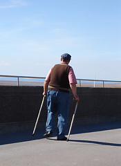 Image showing Old man with walking sticks