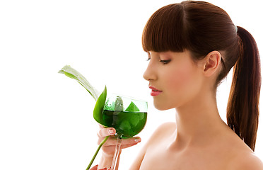 Image showing woman with green leaf and glass of water