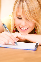 Image showing teenage girl with notebook and pen