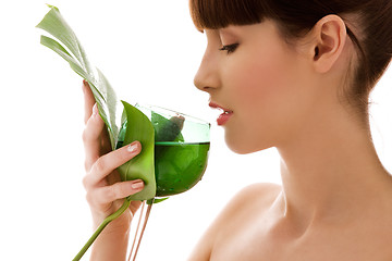 Image showing woman with green leaf and glass of water