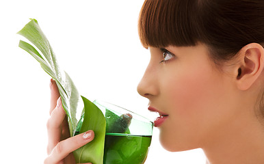 Image showing woman with green leaf and glass of water