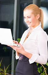 Image showing happy businesswoman with laptop computer