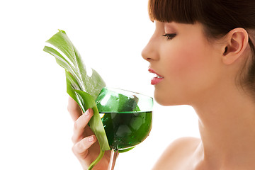 Image showing woman with green leaf and glass of water