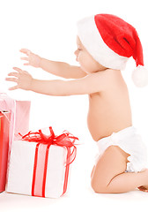 Image showing santa helper baby with christmas gifts