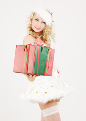 Image showing cheerful santa helper girl with gift box