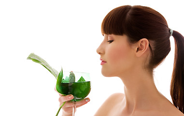 Image showing woman with green leaf and glass of water