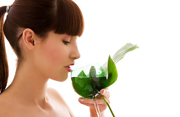 Image showing woman with green leaf and glass of water