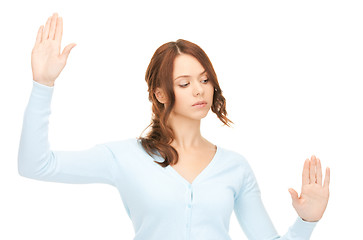 Image showing businesswoman working with something imaginary