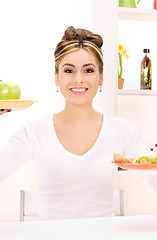 Image showing woman with green apple and sandwich