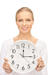 Image showing woman holding big clock