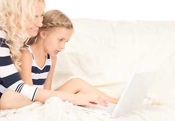 Image showing happy mother and child with laptop computer