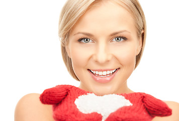 Image showing beautiful woman in red mittens with snow