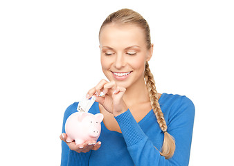 Image showing lovely woman with piggy bank and money