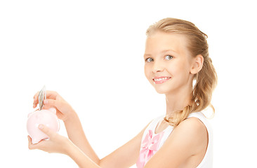 Image showing lovely teenage girl with piggy bank and money