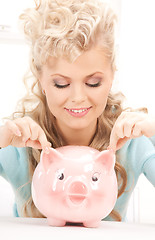 Image showing lovely woman with piggy bank