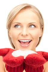 Image showing beautiful woman in red mittens with snow