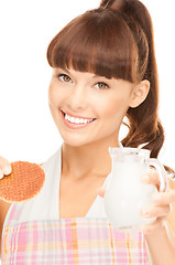 Image showing housewife with milk and cookies