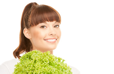 Image showing beautiful housewife with lettuce over white