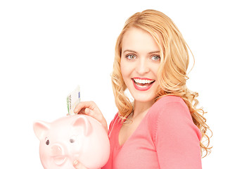 Image showing lovely woman with piggy bank and money