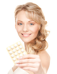 Image showing young woman with pills