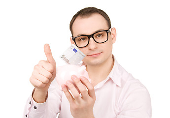 Image showing businessman with piggy bank and money