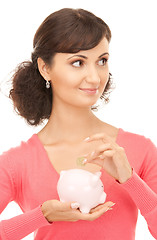 Image showing lovely woman with piggy bank and money